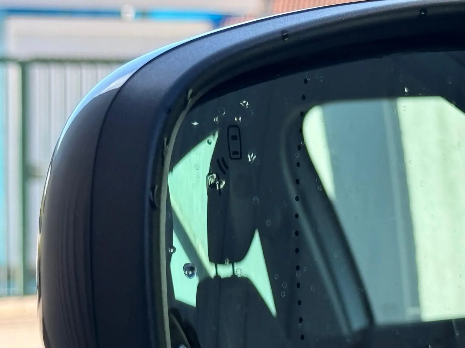 Rétroviseur extérieur droit du Renault Scénic IV gris platine avec toit noir, montrant un reflet partiel de l'habitacle.