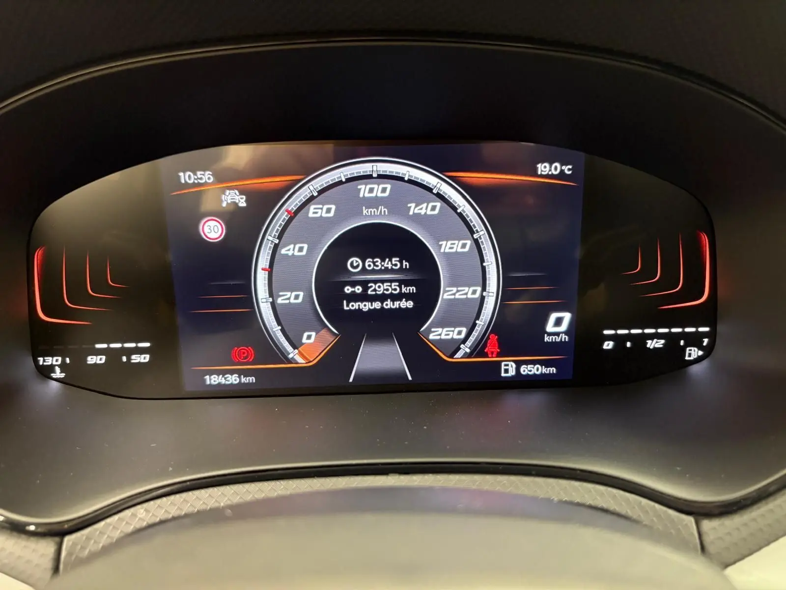 Tableau de bord numérique du SEAT Arona 2023 affichant la vitesse, la température et l'autonomie restante.