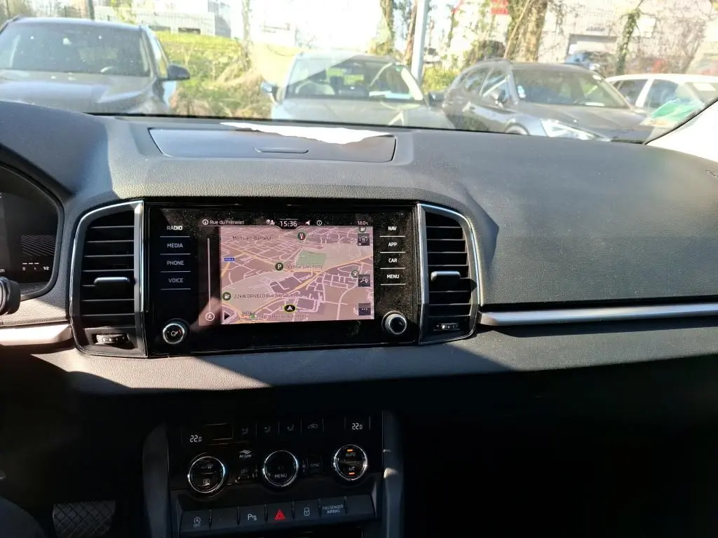 Intérieur noir du Skoda Karoq 2023 vu côté conducteur, avec volant multifonctions et console centrale moderne.