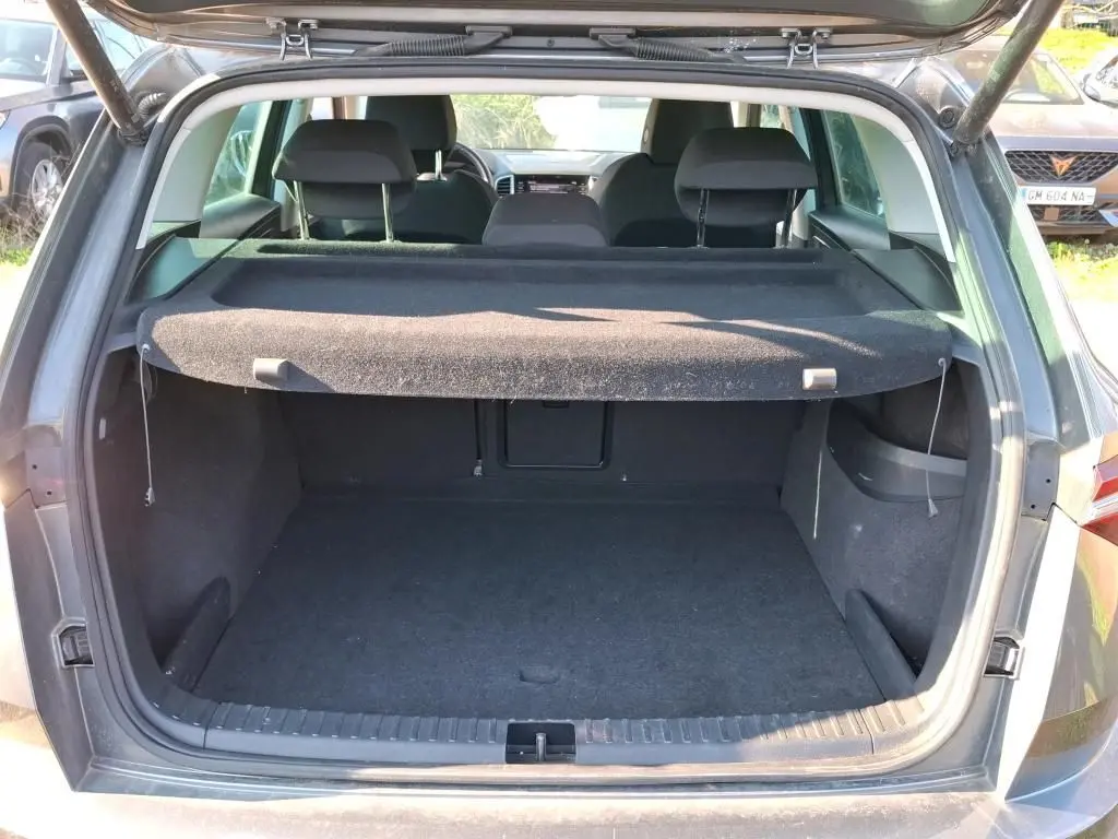 Gros plan sur la roue avant droite avec jante alu 17'' du SUV gris SKODA KAROQ 2023.
