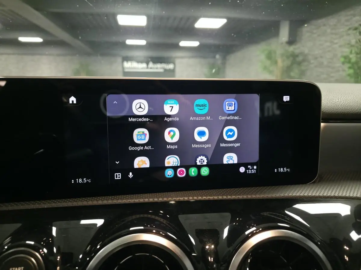 Écran tactile central 10 pouces affichant applications smartphone dans l'habitacle d'une Mercedes Classe A gris métallisé.
