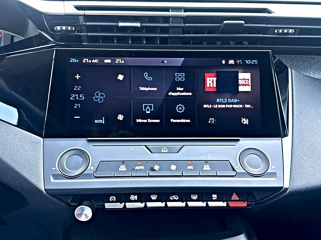 Vue rapprochée de la console centrale de la Peugeot 308 gris 2025, avec écran tactile et commandes climatisation.
