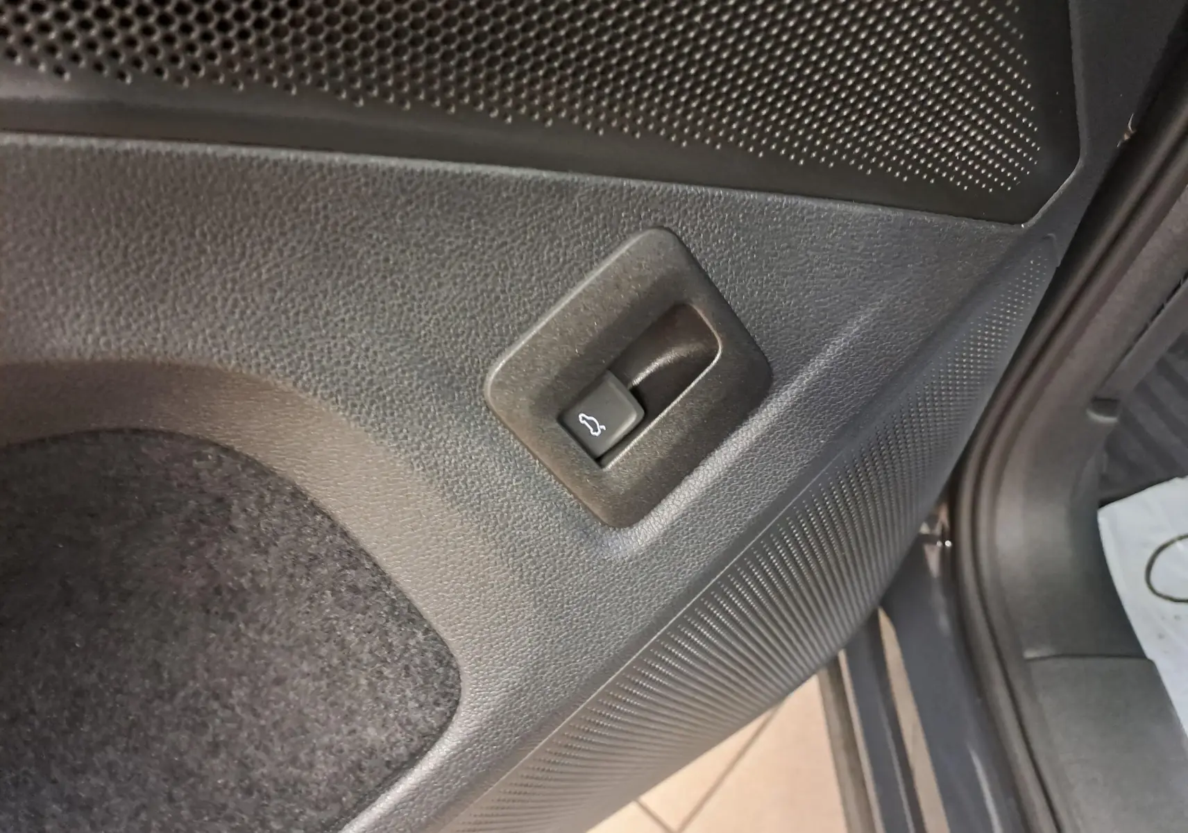 Bouton d'ouverture électrique du hayon sur panneau intérieur du coffre du Volkswagen Tiguan Gris Urano 2024.