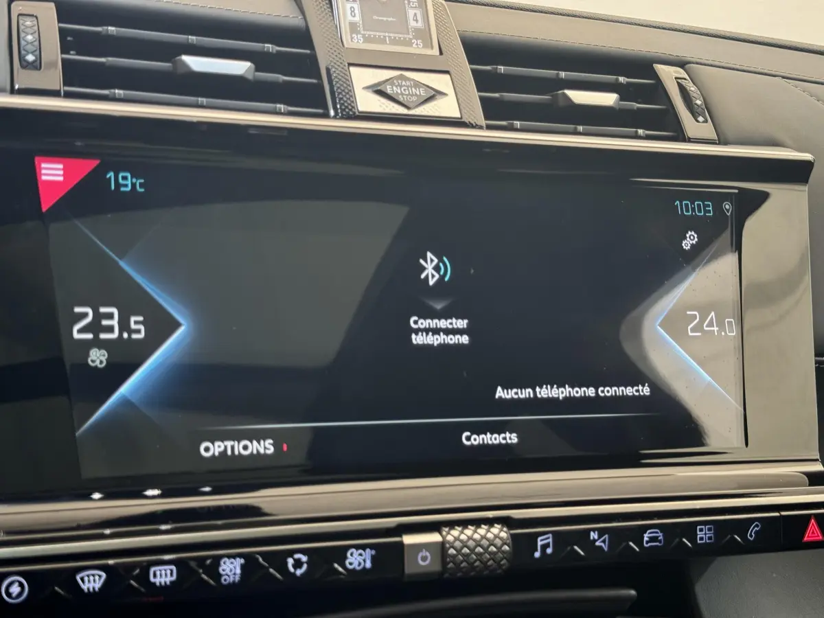Écran tactile central du tableau de bord du DS7 Crossback bleu, affichant la connexion Bluetooth et la climatisation.