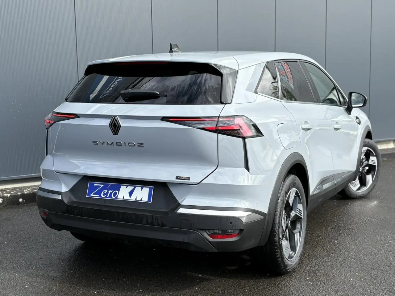 Vue 3/4 arrière droite du Renault SYMBIOZ gris Rafale avec feux LED fins et jantes 18 pouces distinctives.