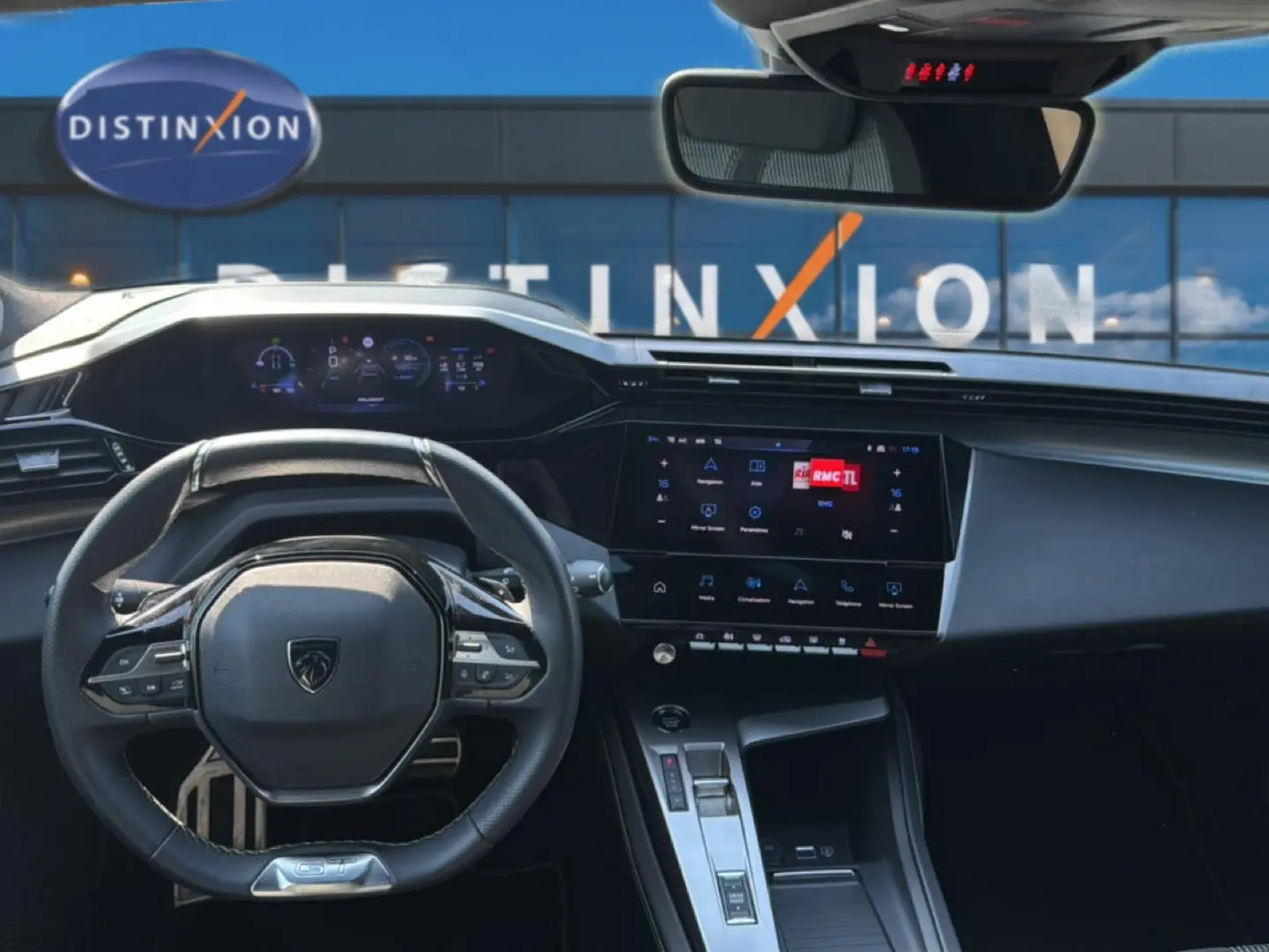 Vue intérieure avant du tableau de bord et volant noir de la Peugeot 308 1.2 hybrid 145 GT e-DCS6 2025, avec écran tactile et affichage numérique.