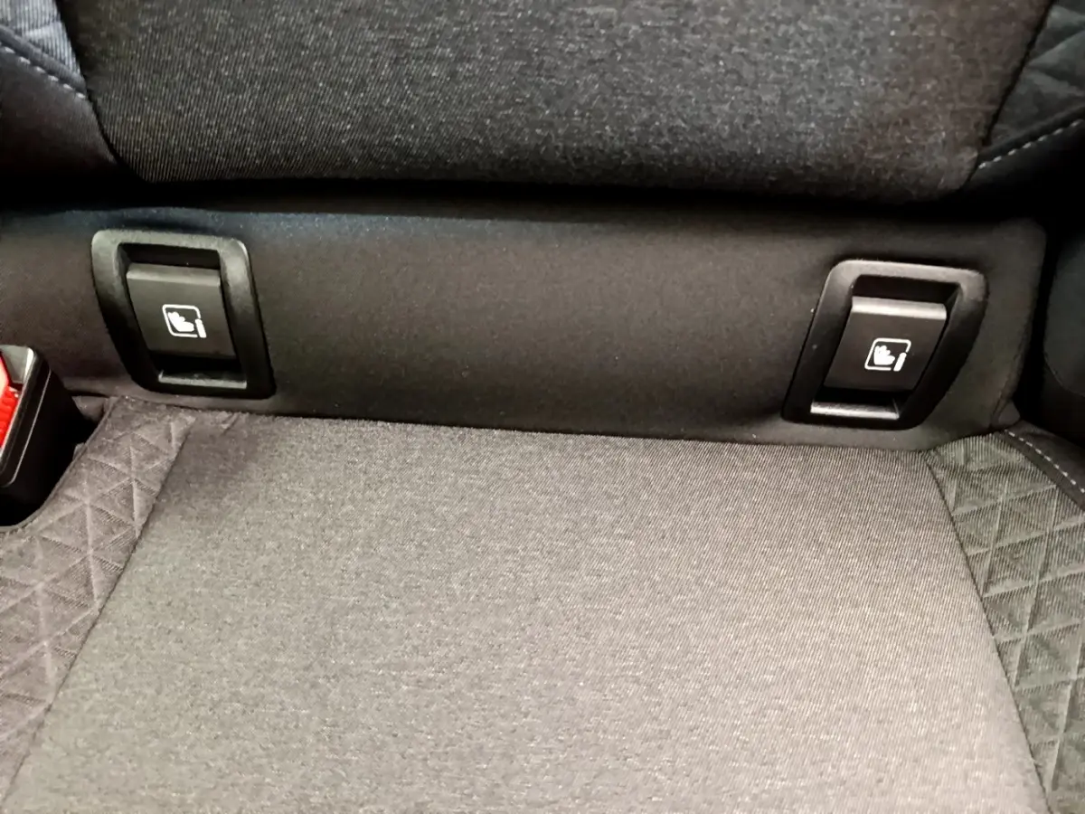 Détail des commandes de rabattement des sièges arrière sur une Renault Clio Business TCe 100 gris clair, vue intérieure rapprochée.