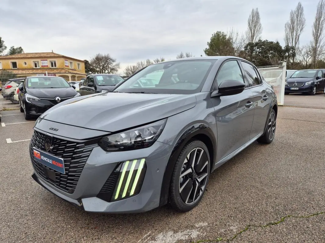 Peugeot 208 Hybrid gris vue 3/4 avant droit, avec feux diurnes verticaux distinctifs et jantes alliage 17 pouces.