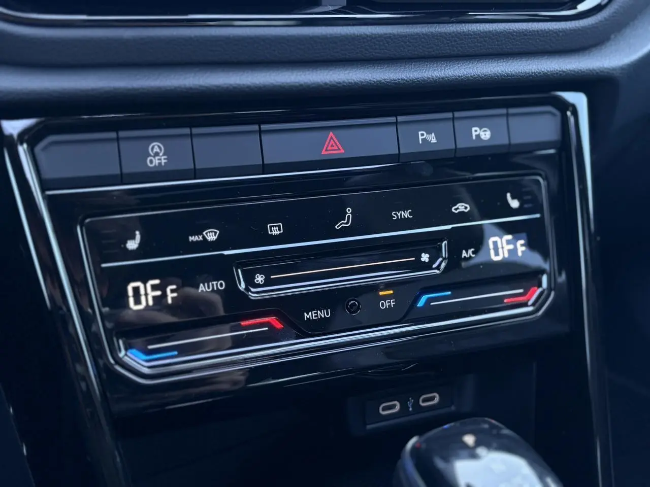 Gros plan sur la console centrale du Volkswagen T-Roc 2025 gris pyrite, affichant la climatisation automatique éteinte.