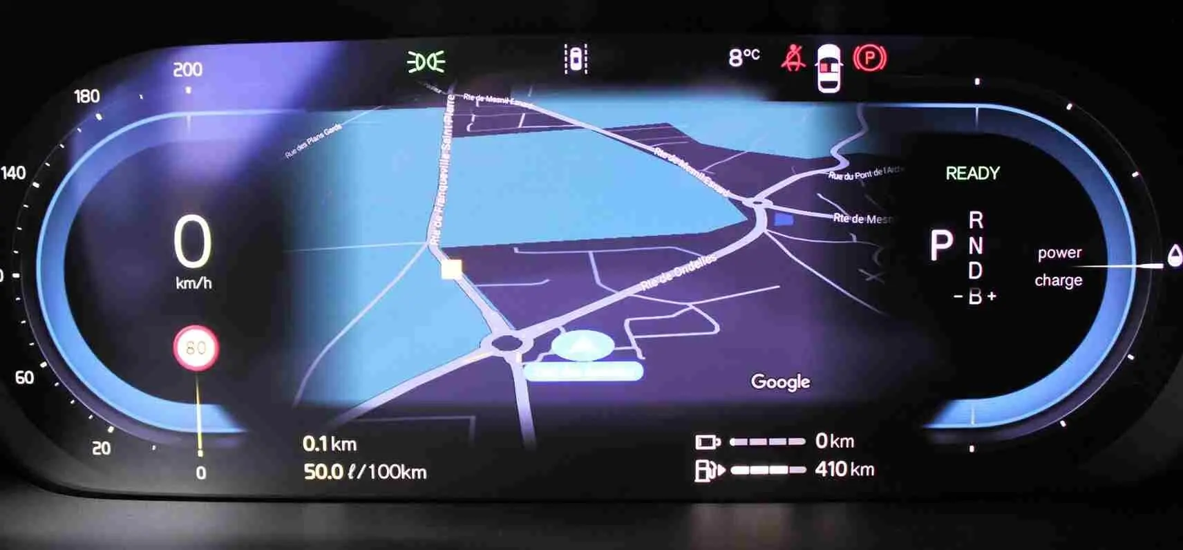 Tableau de bord numérique du Volvo S60 hybride rechargeable 2024 affichant la navigation, vitesse à 0 km/h et indicateurs de charge.