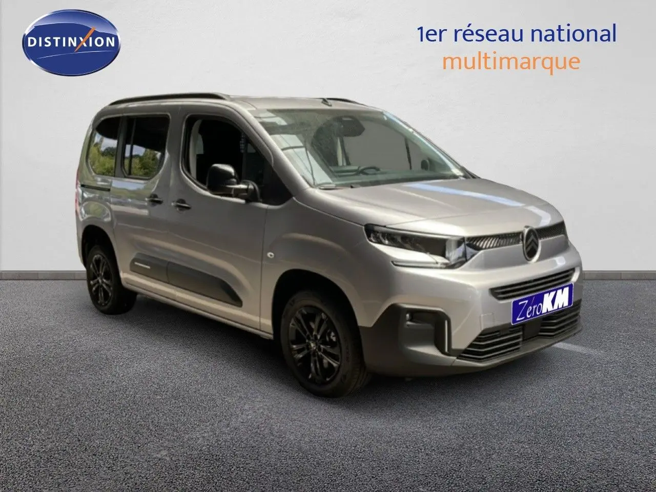 Vue 3/4 avant droite d'un Citroën Berlingo gris Artense métallisé avec jantes noires et vitres teintées.