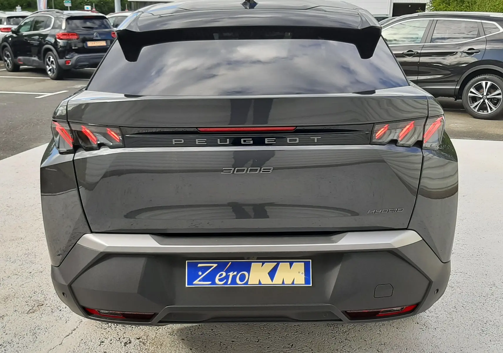 Vue arrière du Peugeot 3008 gris titane 2026 avec feux LED caractéristiques et badge Hybrid visible sur le hayon.