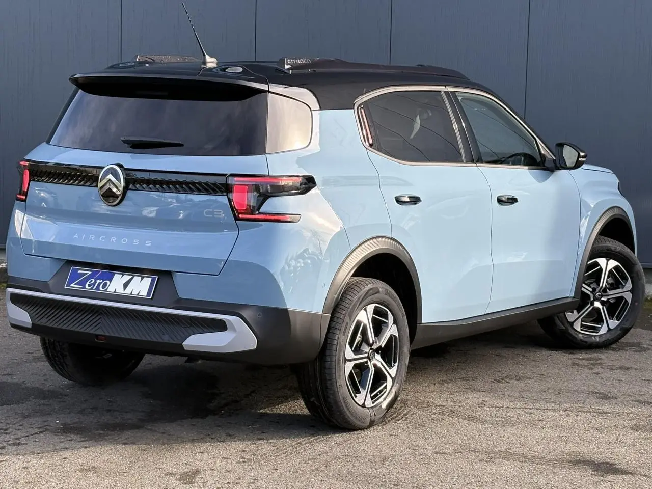 Vue 3/4 arrière droite du Citroën C3 Aircross Hybrid 145 bleu Monte Carlo avec toit noir et jantes diamantées.