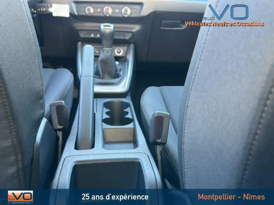 Vue rapprochée de la console centrale et des sièges noirs de l'Audi A1 Sportback 30 TFSI 2019 avec boîte manuelle.
