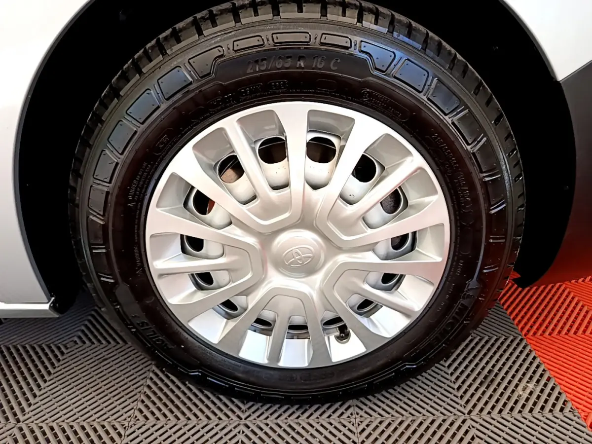 Gros plan sur la roue avant droite du Toyota Proace Verso gris clair, mettant en valeur la jante acier et le pneu neuf.