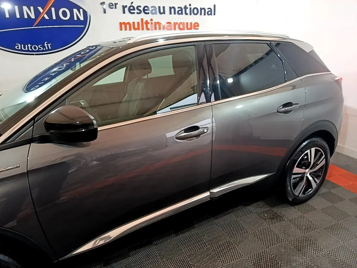Vue latérale droite d’un Peugeot 3008 gris foncé avec jantes alliage et rétroviseur noir brillant.