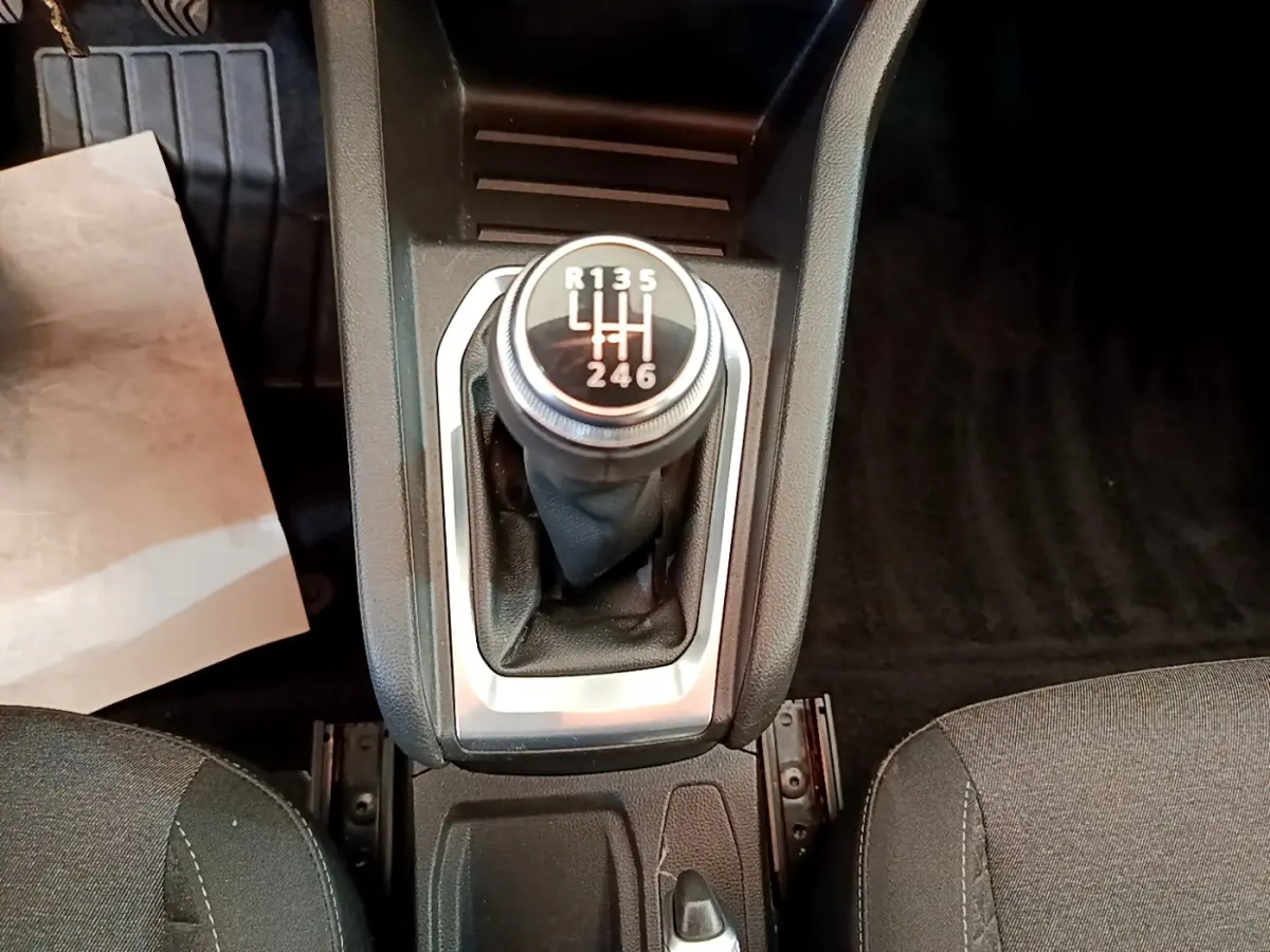 Gros plan sur le levier de vitesses manuel noir de la Renault Clio Business Blue dCi 85, entouré de garnitures grises.