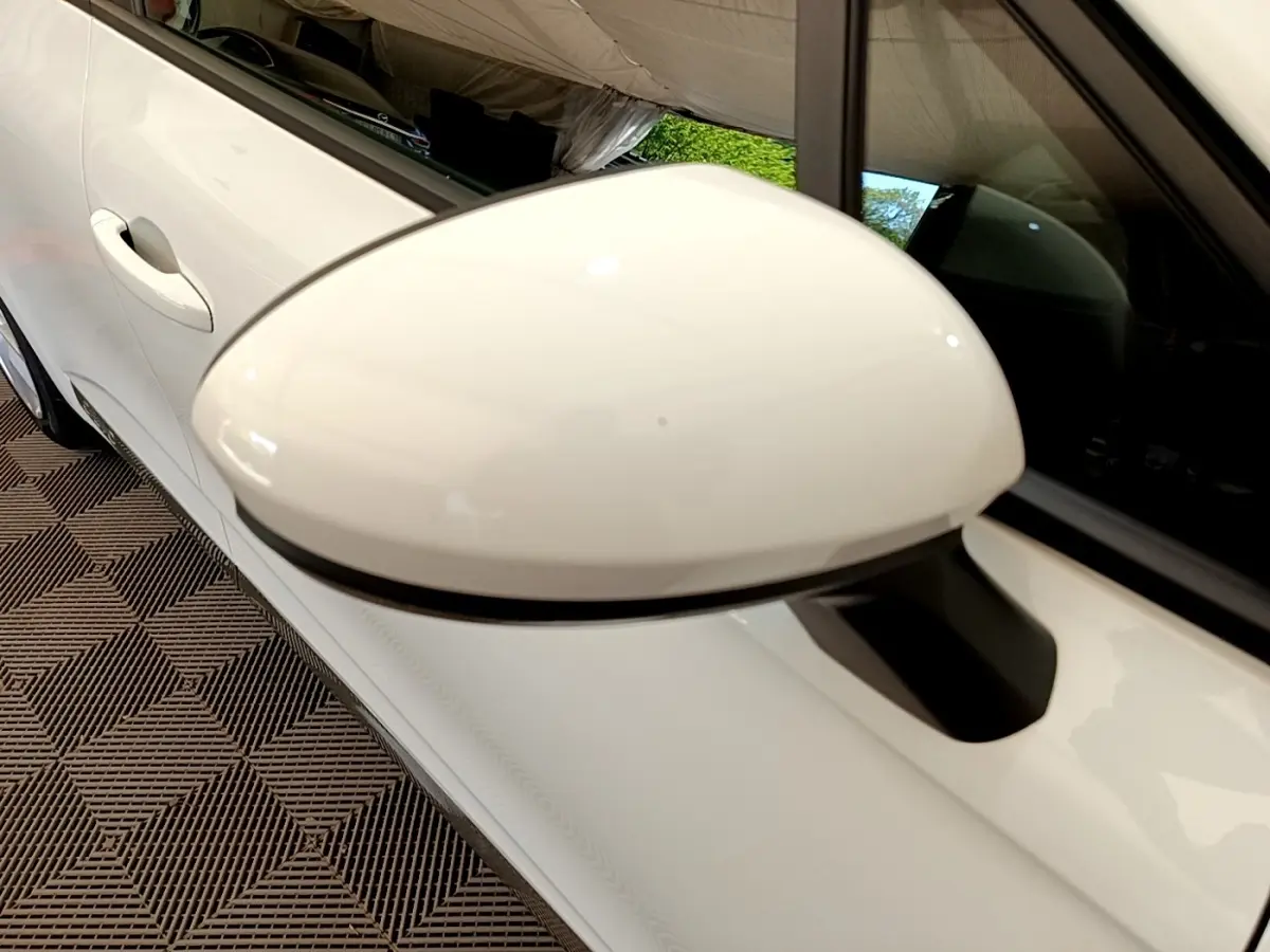 Gros plan sur le rétroviseur droit blanc d’une Renault Clio Business Blue dCi 85 de 2020, vue côté extérieur.