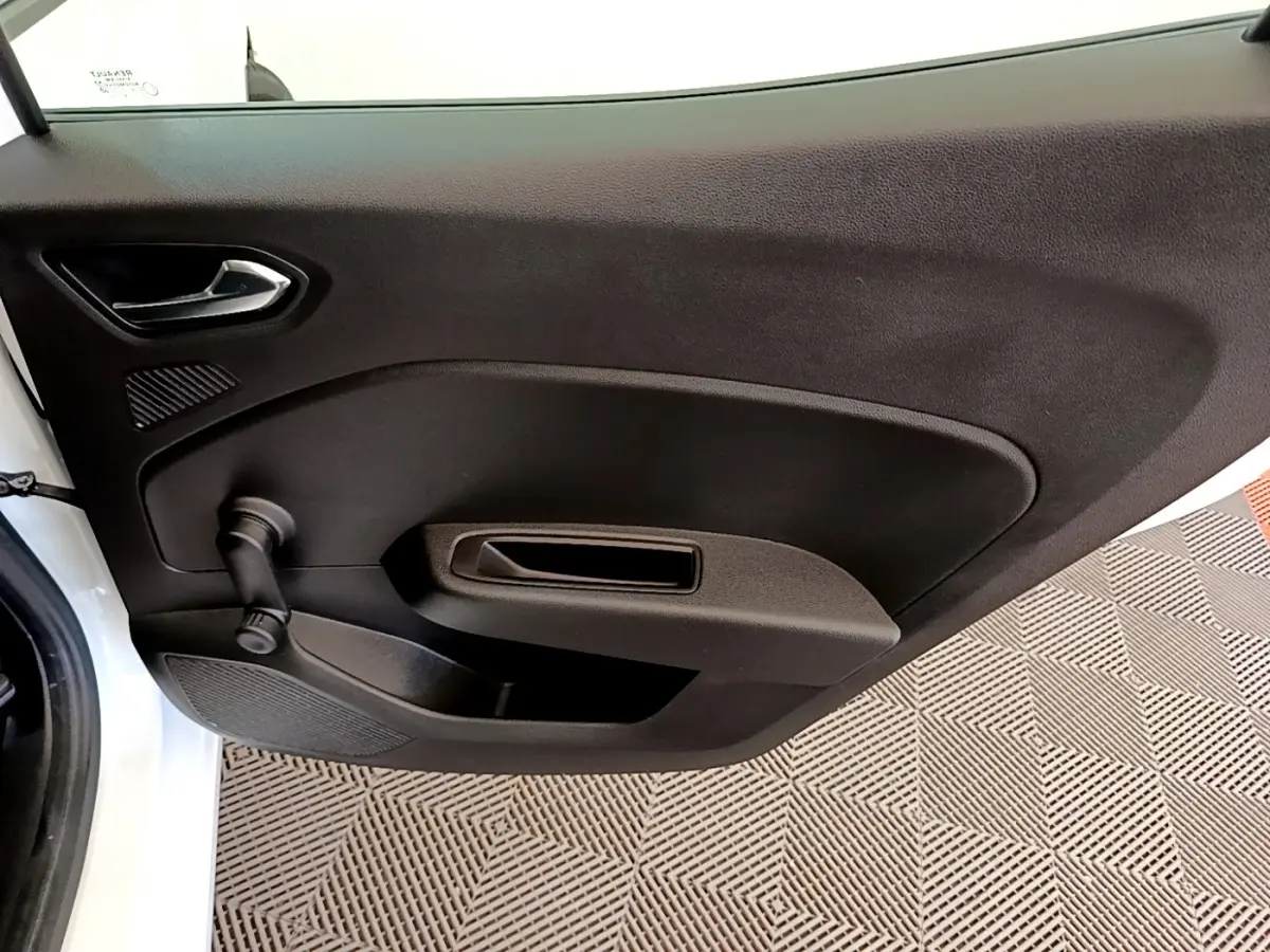 Vue rapprochée de la porte avant gauche noire d'une Renault Clio Business Blue dCi 85 blanche, avec manivelle de vitre.
