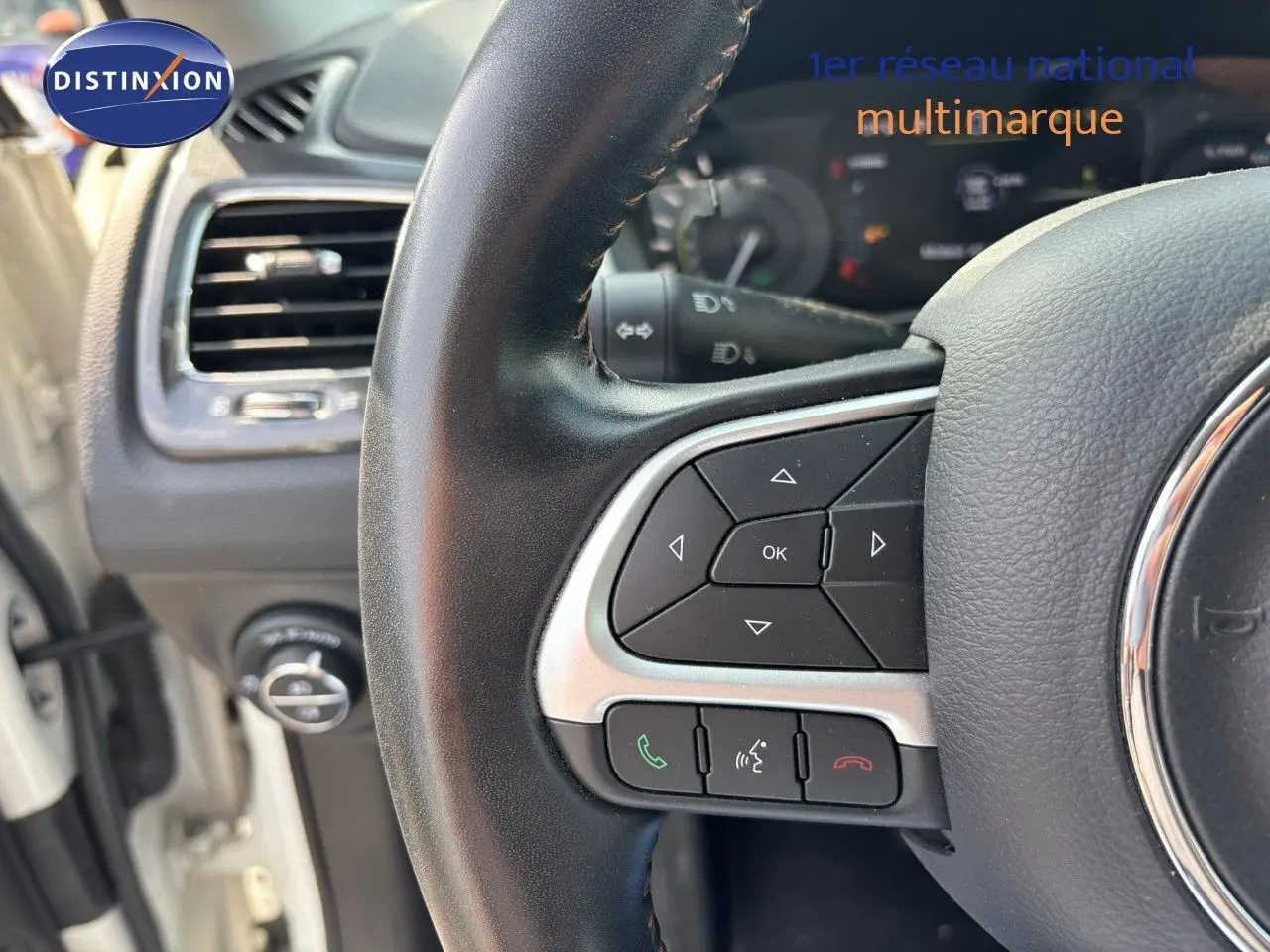 Gros plan sur le volant cuir noir du Jeep Compass 2021, mettant en valeur les commandes multifonctions côté gauche.