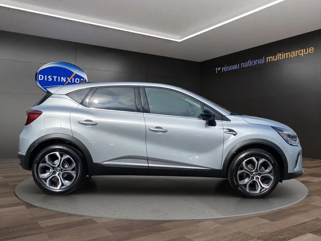 Profil côté gauche du Renault Captur gris Highland 2024 avec jantes alliage et détails noirs contrastants.