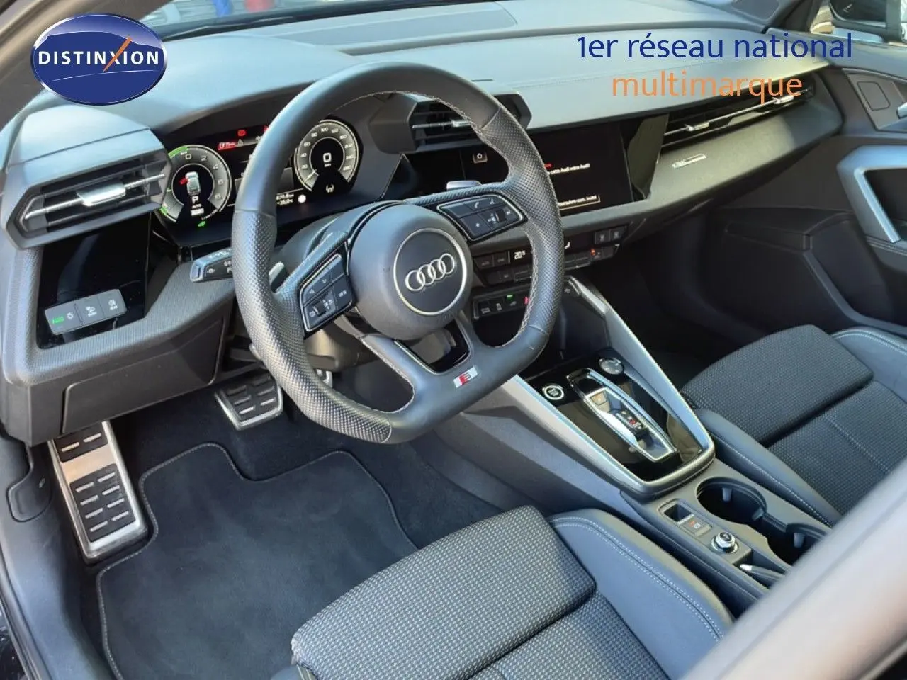 Vue intérieure côté conducteur de l'Audi A3 Sportback noire 2025, avec volant cuir perforé et tableau de bord digital.