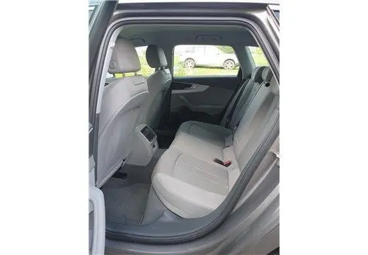 Vue intérieure arrière côté gauche de l'Audi A4 Avant Business 2020 gris Terra, montrant les sièges arrière en tissu clair.