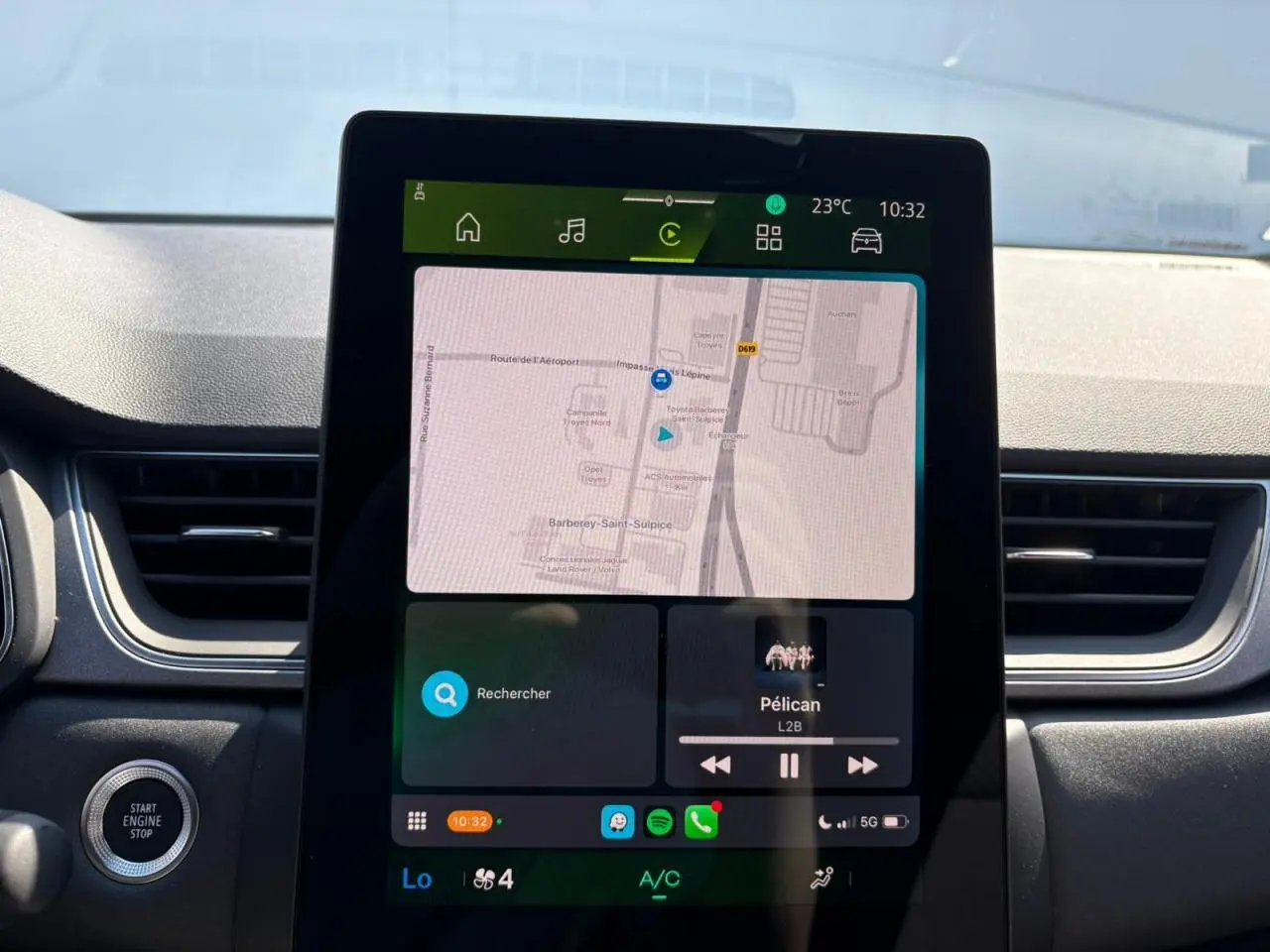Écran tactile central affichant la navigation et la musique dans l'habitacle du Renault Symbioz blanc nacré.