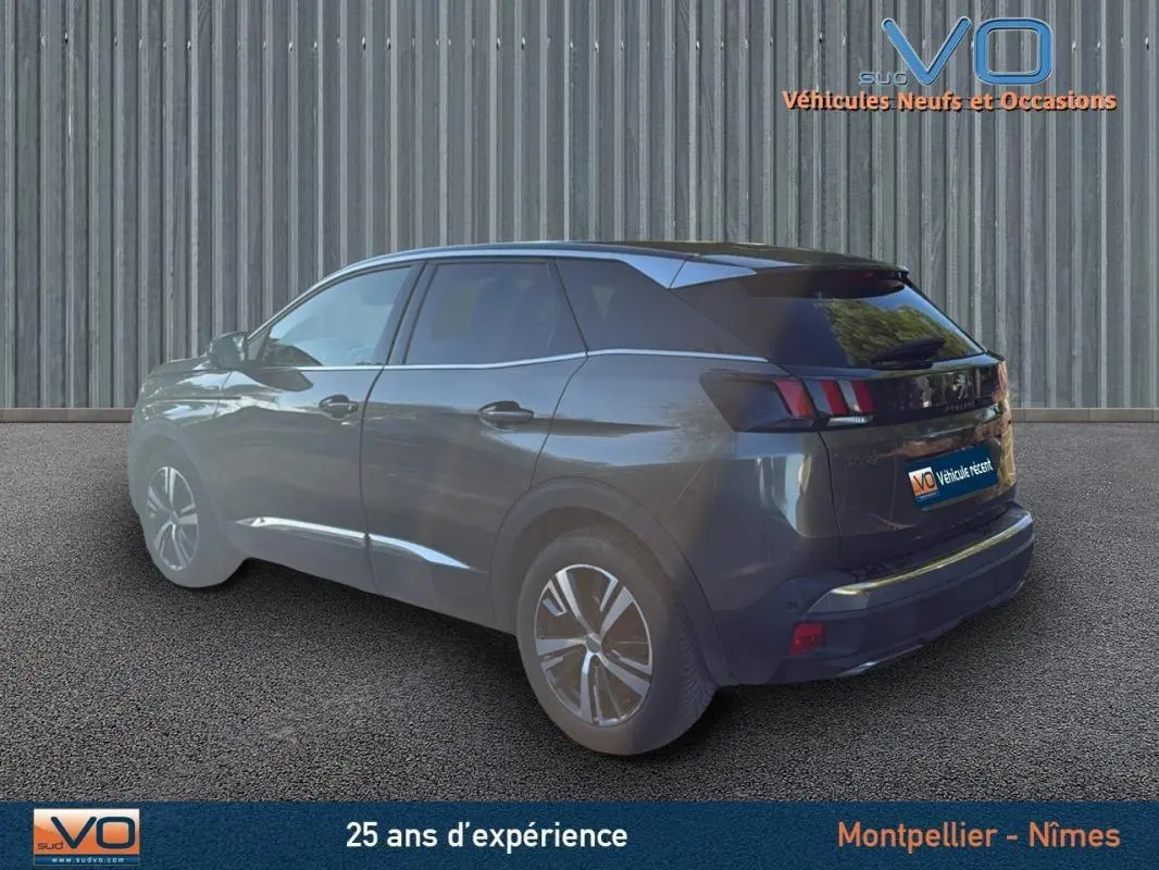 Peugeot 3008 gris foncé vue 3/4 arrière droit, avec jantes alliage 18 pouces et feux arrière à griffes distinctifs.