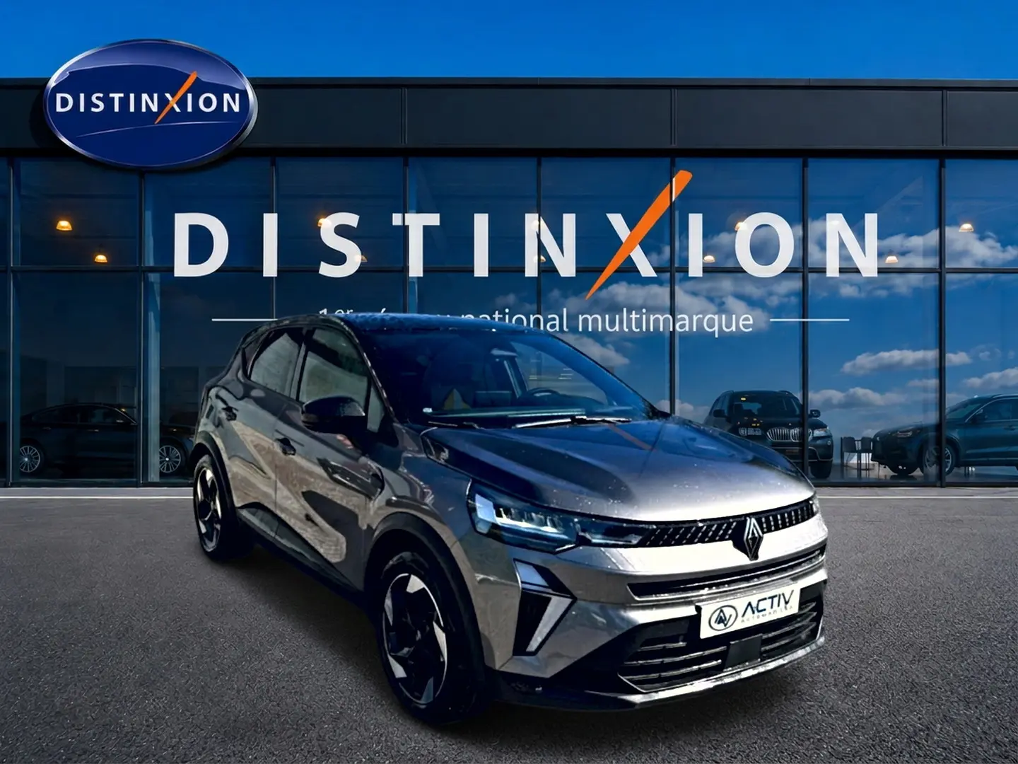 Renault Captur gris cassiopée en 3/4 avant droit, avec calandre moderne et jantes noires distinctives.