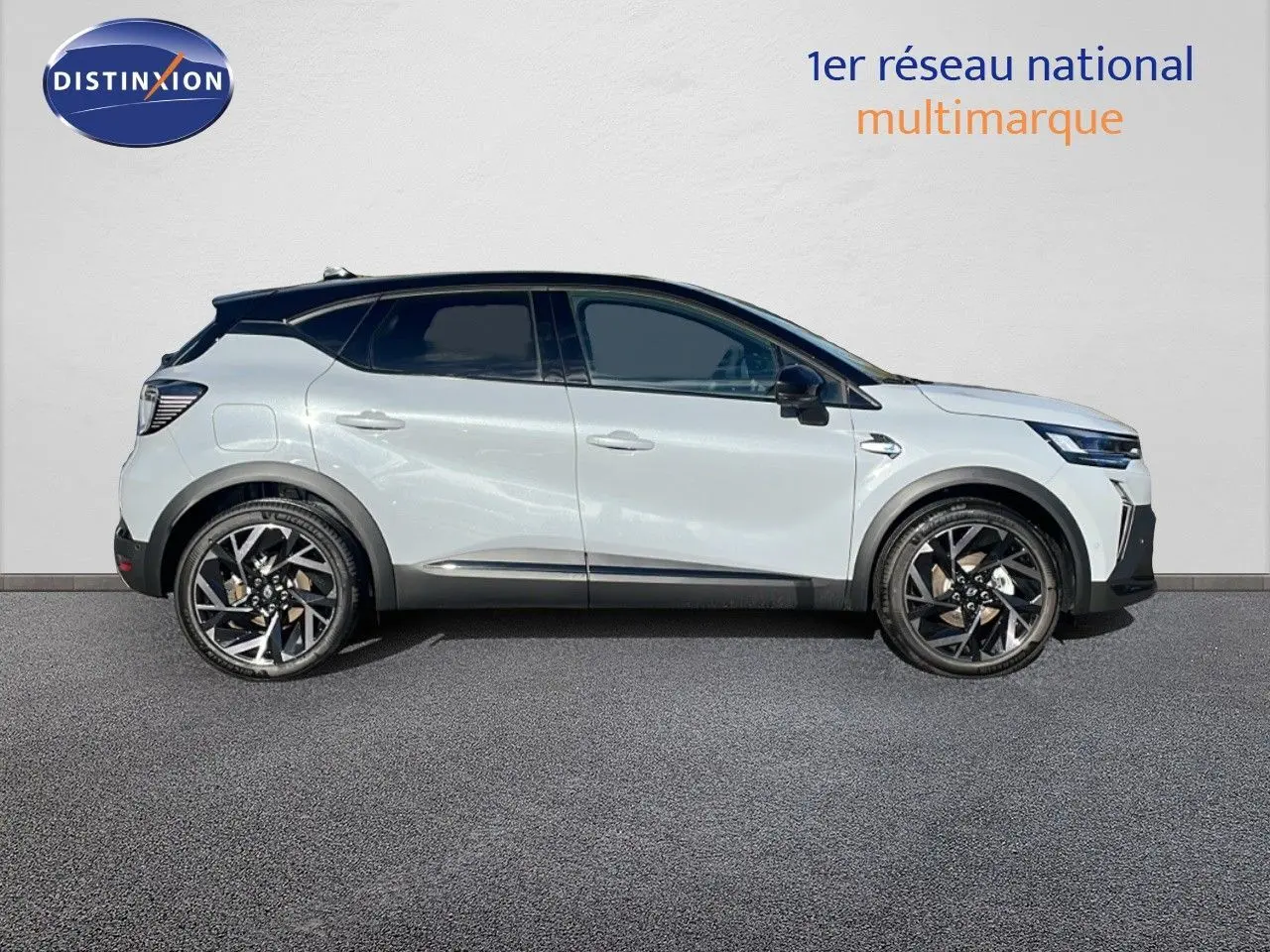 Profil latéral droit du Renault Captur E-Tech hybride 2025 en gris rafale métal avec toit noir et jantes noires.