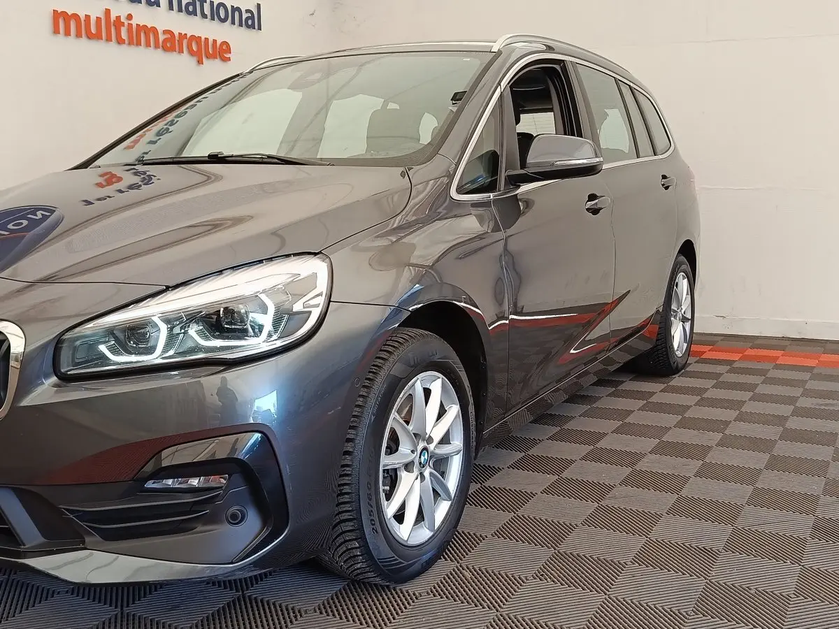 BMW Série 2 Gran Tourer gris clair vue 3/4 avant droit, phares LED et jantes alliage visibles.