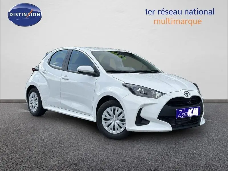 Toyota Yaris 116h Dynamic 5p blanc vue 3/4 avant avec calandre noire et jantes cache-moyeux blancs