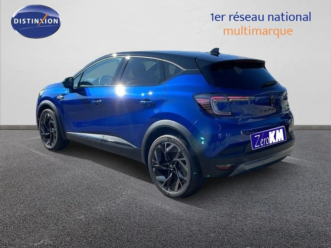 Vue 3/4 arrière droite du Renault Captur E-Tech hybride 2025 bleu Iron Metal avec toit noir et jantes noires.
