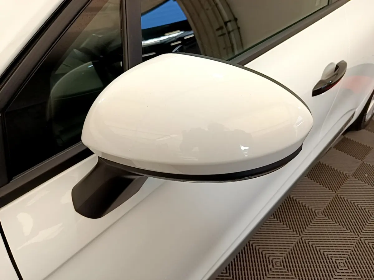 Rétroviseur droit blanc de la Renault Clio Business 2021, avec poignée de porte noire et carrosserie blanche visible en plan rapproché.