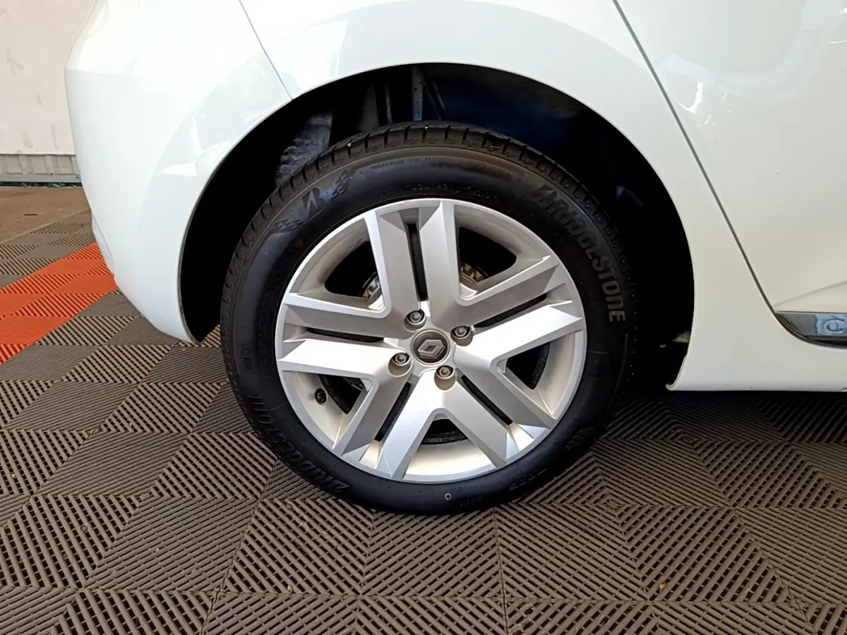 Gros plan sur la roue arrière droite blanche d'une Renault Clio Business 2021 avec jante alliage et pneu Bridgestone.