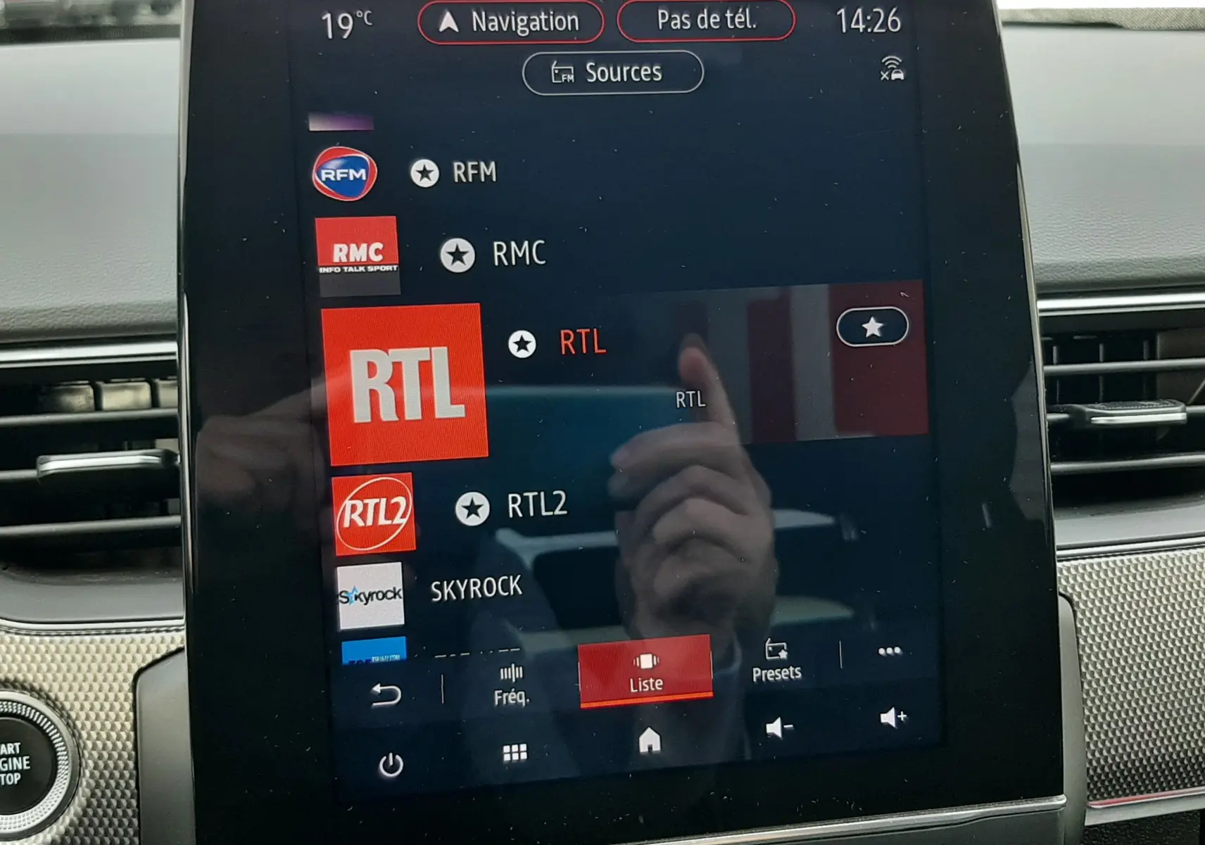 Écran central tactile de la Renault Arkana 1.6 E-TECH 145 Intens affichant la liste des radios, intérieur noir visible.