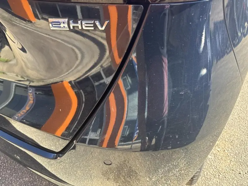 Gros plan sur l'arrière droit bleu nuit nacré d'une Honda Jazz 1.5 i-MMD e:HEV avec logo e:HEV visible.