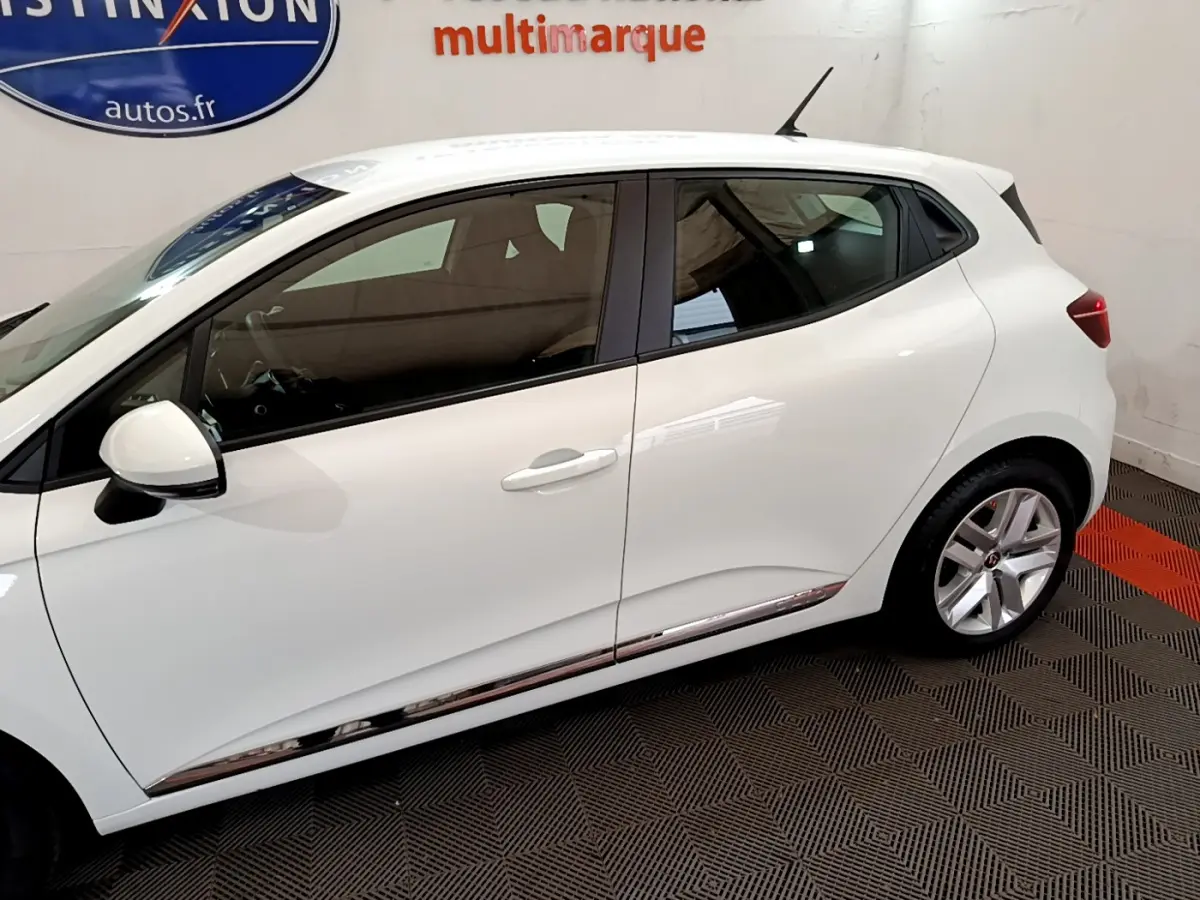 Profil côté gauche de la Renault Clio Business blanche 2021, soulignant ses lignes épurées et ses jantes alliage.