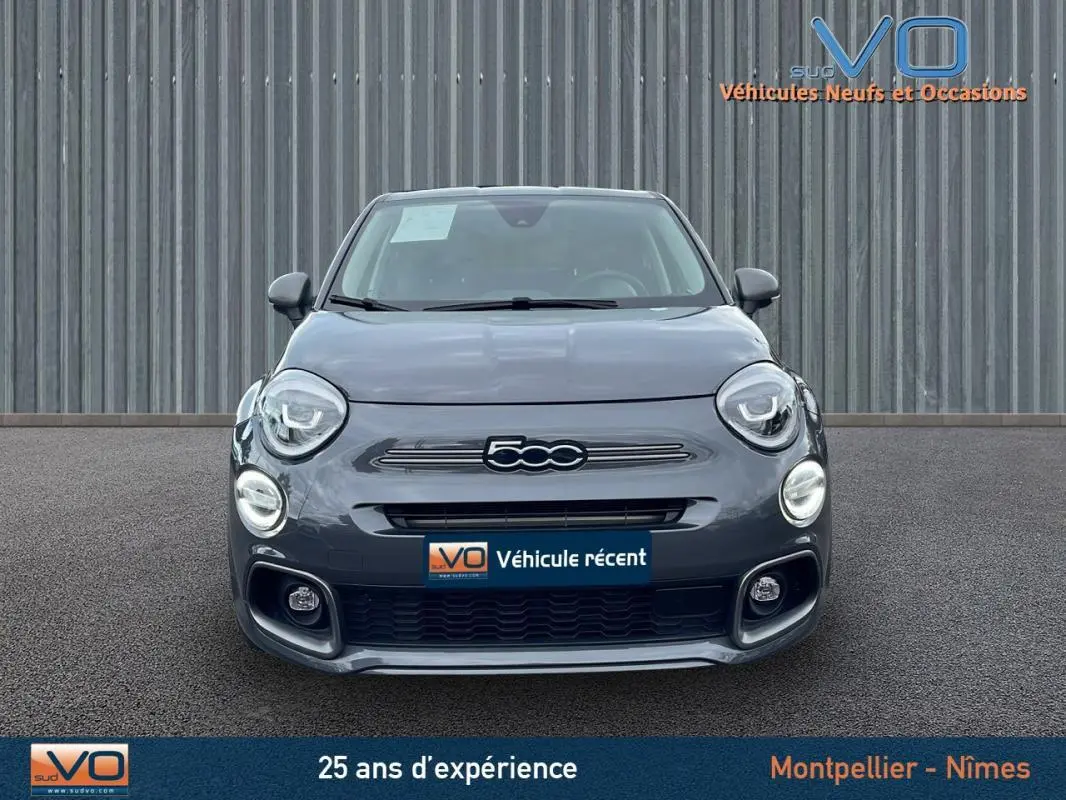 Vue frontale d'une FIAT 500X MY22 gris métallisé avec phares ronds et calandre distinctive sport.