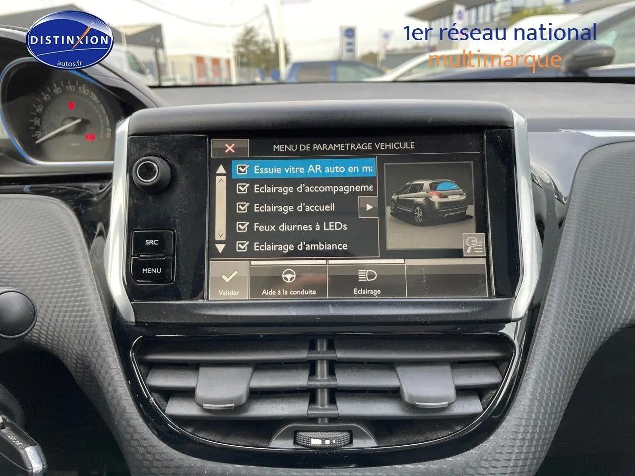 Écran tactile central affichant les réglages du véhicule Peugeot 2008 blanc, vue intérieure du tableau de bord.