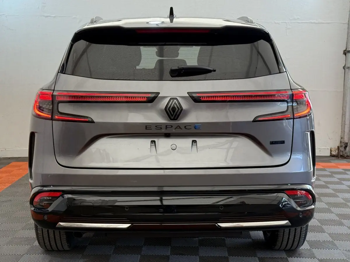Vue arrière d'un Renault Espace gris foncé hybride avec feux LED horizontaux et logo central lumineux.