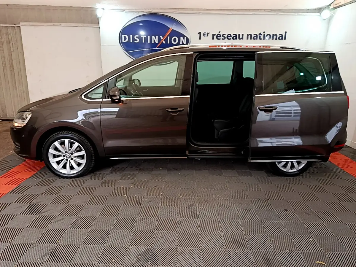 Volkswagen Sharan marron vue de profil gauche avec porte coulissante arrière ouverte en intérieur showroom.