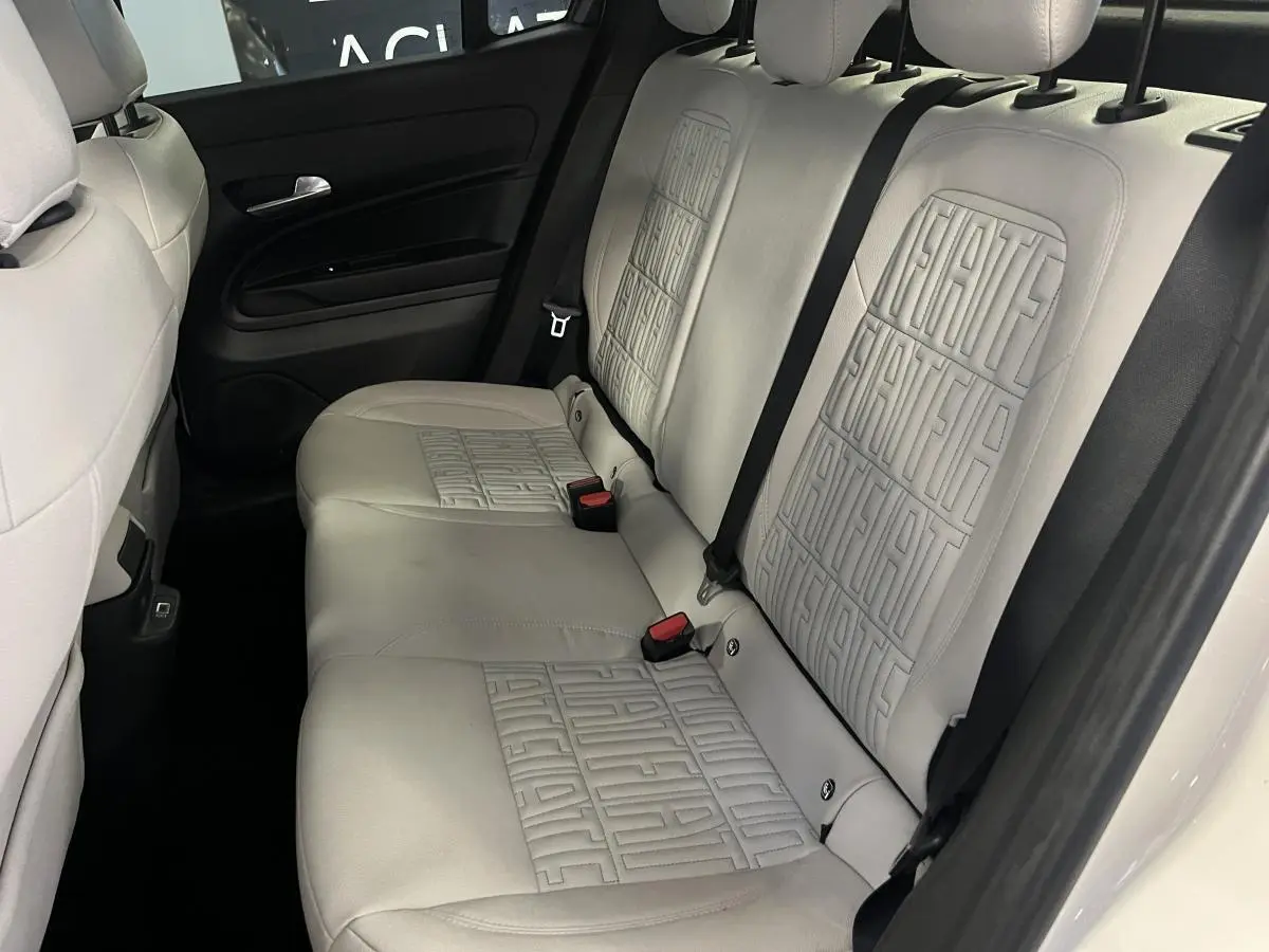 Vue intérieure arrière de la banquette ivoire soft touch avec monogrammes FIAT embossés sur la Fiat 600 blanche 2024.