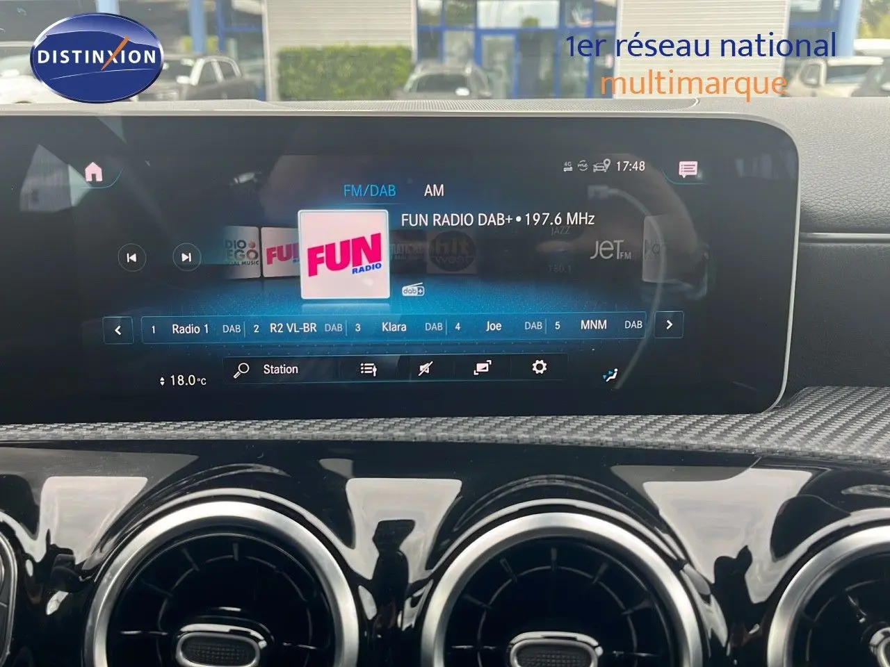 Écran multimédia et tableau de bord noir brillant d'une Mercedes Classe CLA Shooting Brake 180 argent iridium, affichant la radio Fun.