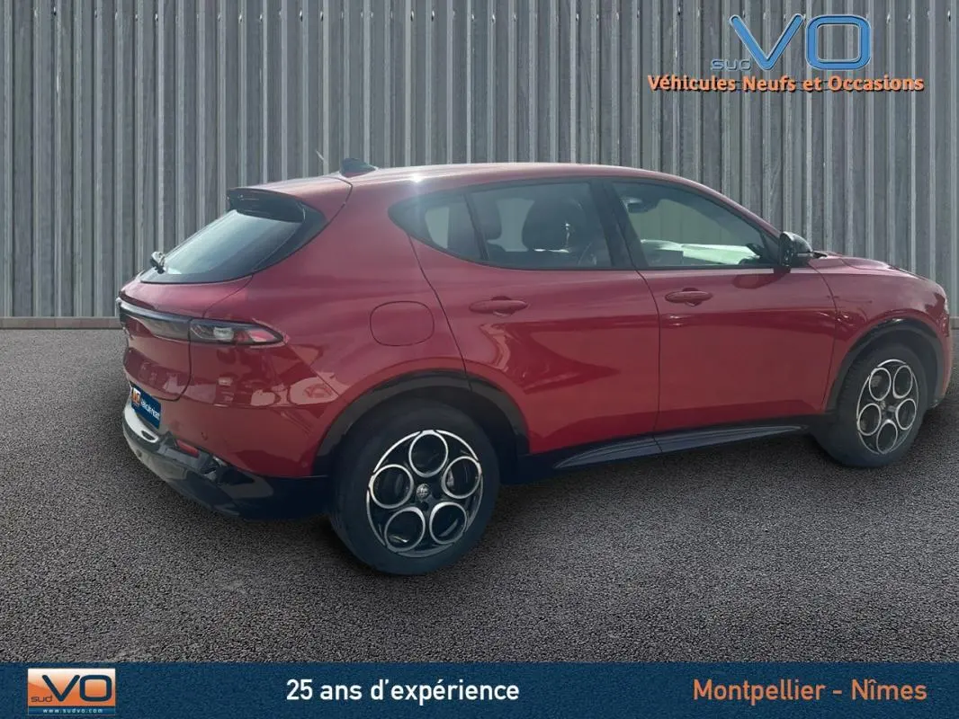 Vue latérale droite d'une Alfa Romeo Tonale rouge 2024 avec jantes distinctives et lignes fluides du SUV compact.