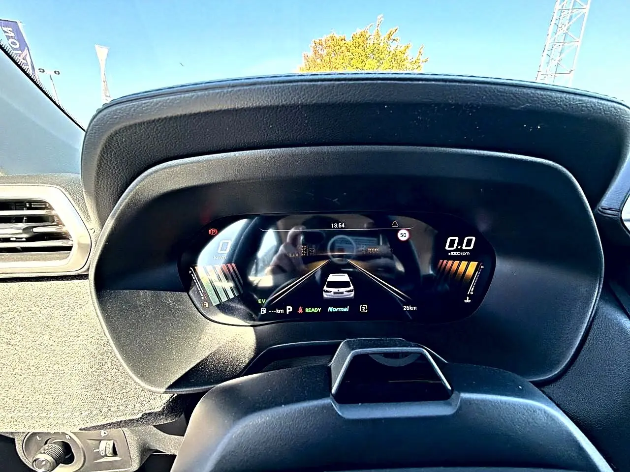 Vue rapprochée du tableau de bord numérique du MG Motor ZS 1.5 hybrid 197 noir, affichant la vitesse et l'autonomie.