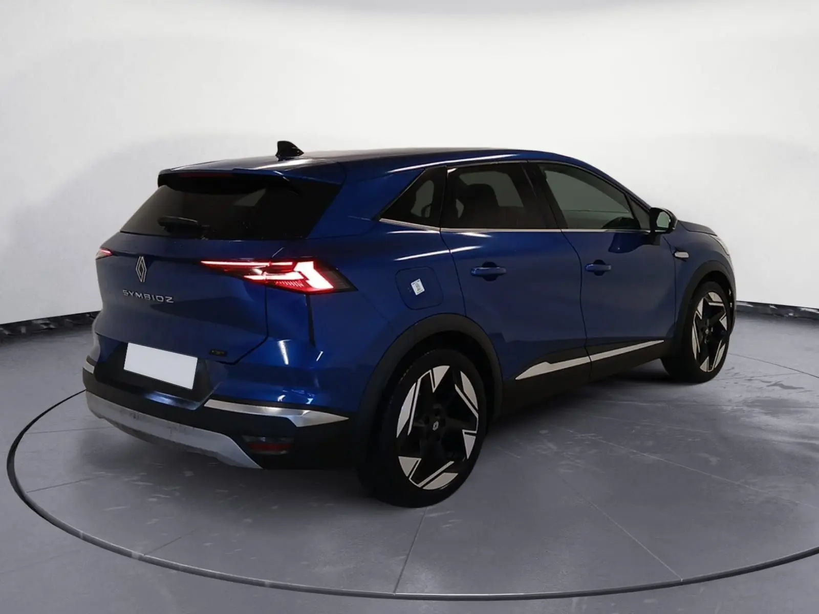 Vue 3/4 arrière droite du Renault Symbioz E-Tech Full Hybrid 145 Iconic 2025 en bleu Iron avec feux LED et jantes distinctives.