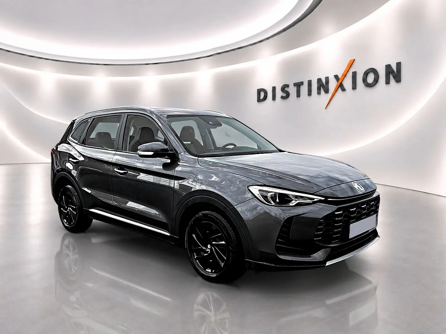 MG ZS 1.5 hybrid 197 Camden grey en 3/4 avant droit, avec jantes noires et calandre imposante dans un showroom lumineux.