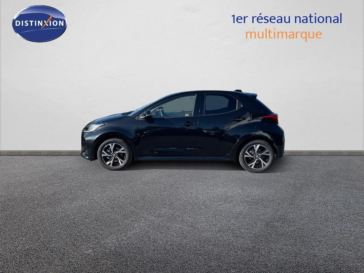 Profil côté gauche d'une Toyota Yaris Hybrid 116ch Design noire métal 2025, avec jantes alliage bicolores.